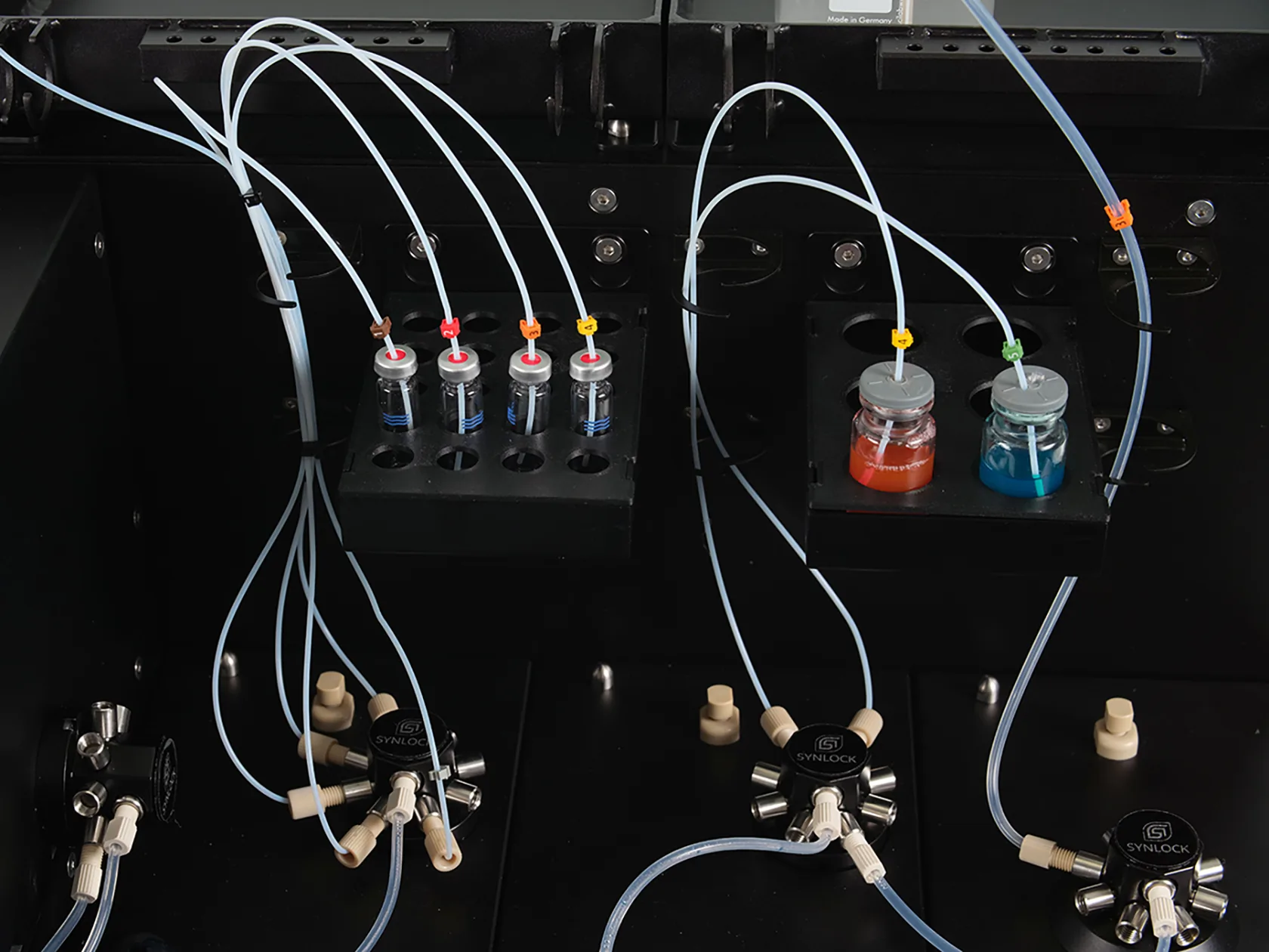 Multiple bottles connected to the dispensing unit with tubes